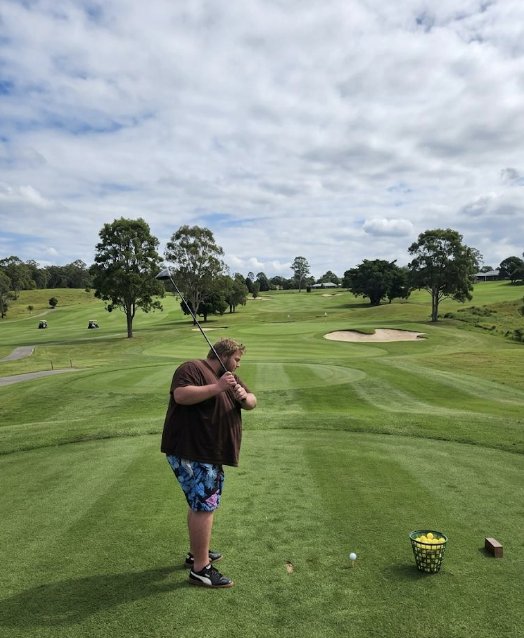 Xavier lining up a tee shot on a golf course